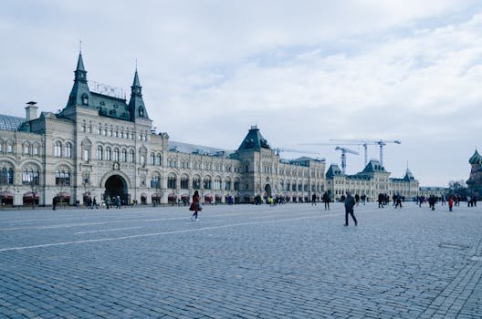 Historic GUM department store facade at Red Square under a cloudy sky, Moscow, Russia.