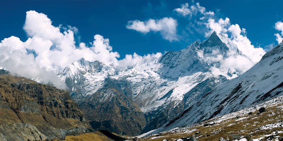 Majestic snow-capped peaks of Annapurna in clear daylight, perfect for outdoor enthusiasts.